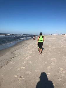 Women in yellow walking on beach